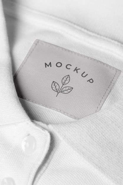 the label on a white shirt that says mock mock up with a small green leaf