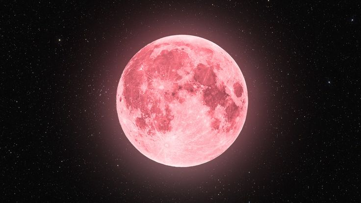 a red full moon with stars in the background