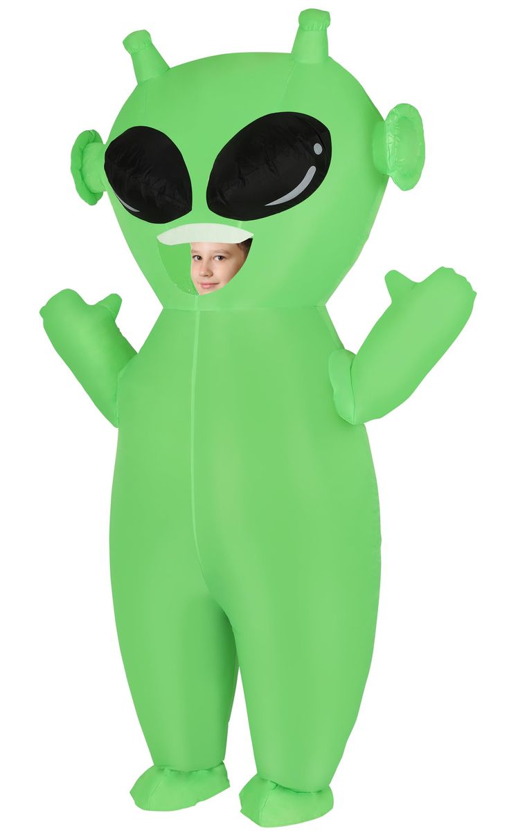 a child in a green alien costume