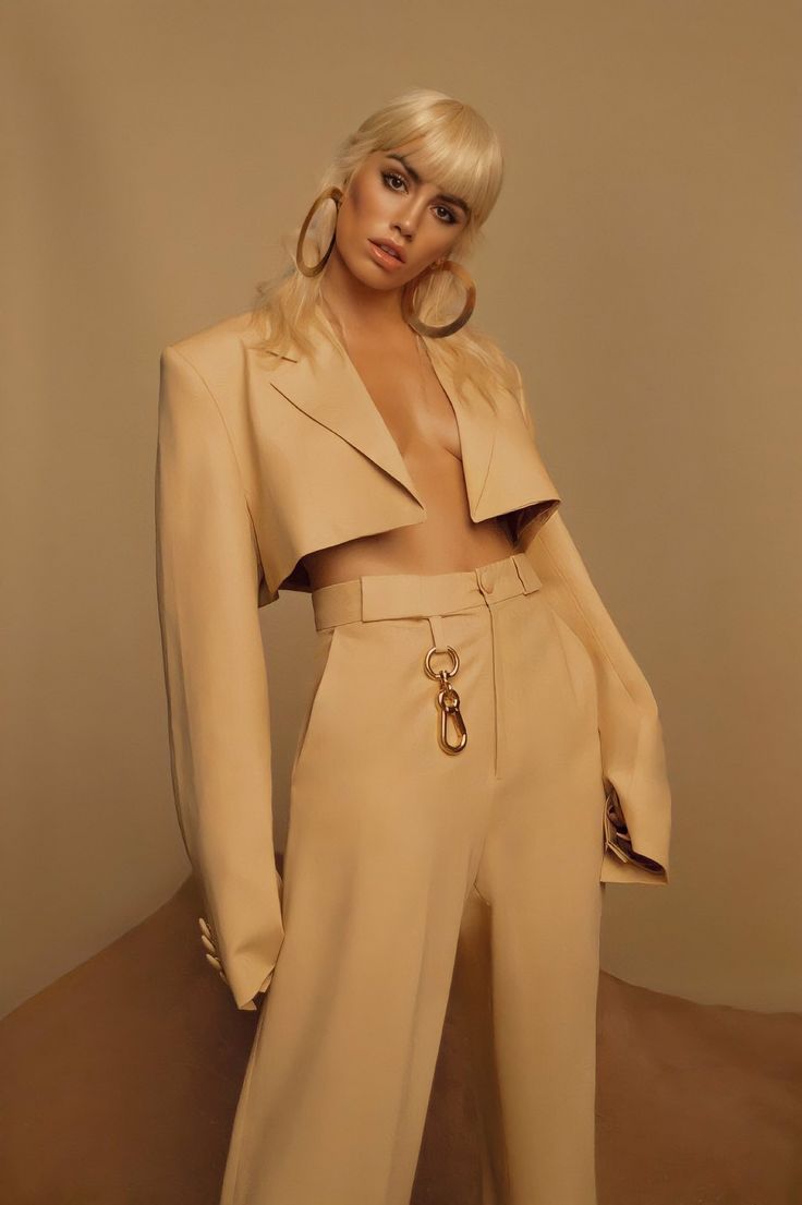 a woman with blonde hair wearing a beige suit