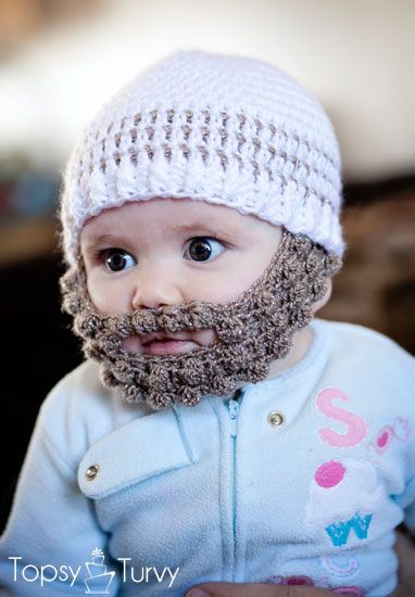 a baby with a beard wearing a white knitted hat