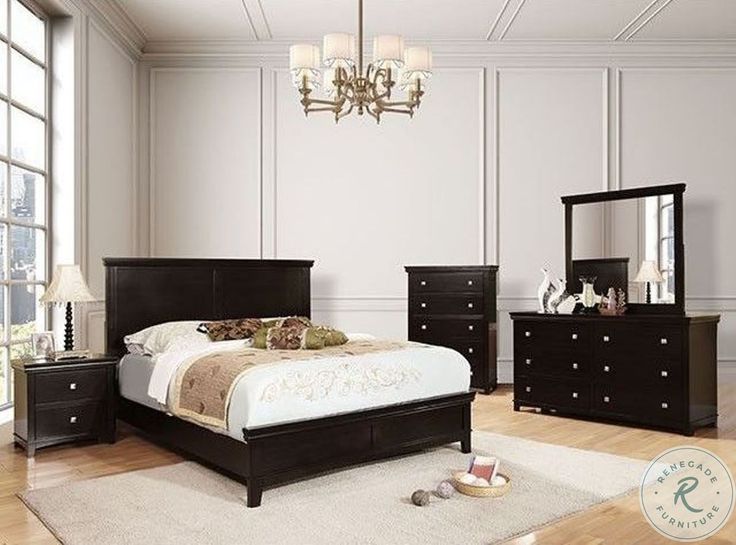 a bedroom with white walls and black furniture