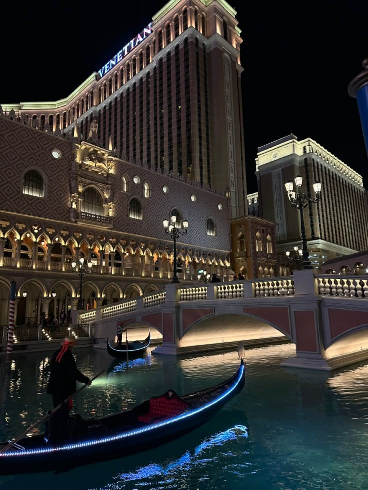 a gondola in front of the las vegas strip hotel and casino at night