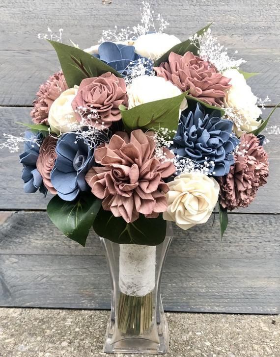 a vase filled with lots of different colored flowers