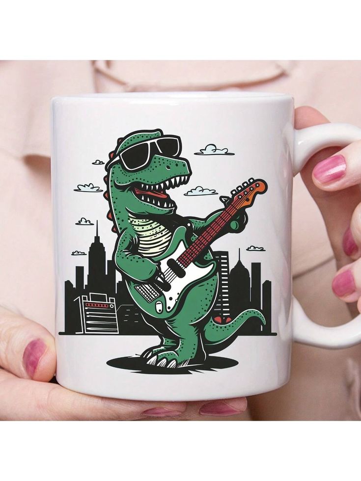 a person holding a white coffee mug with a dinosaur playing the guitar