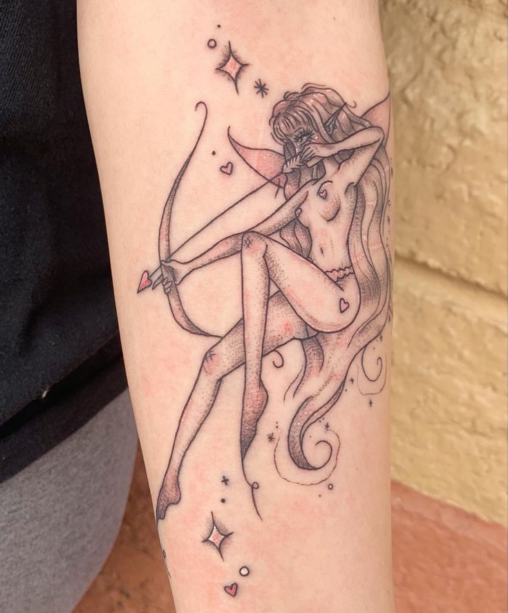 a woman with a bow and arrow tattoo on her arm