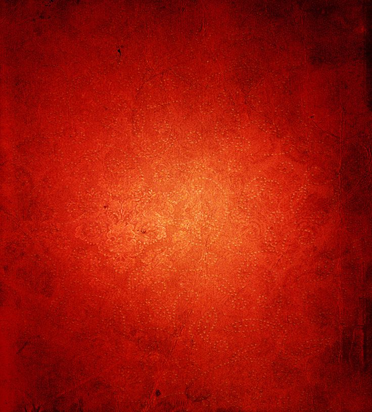 an orange and red background with some black spots