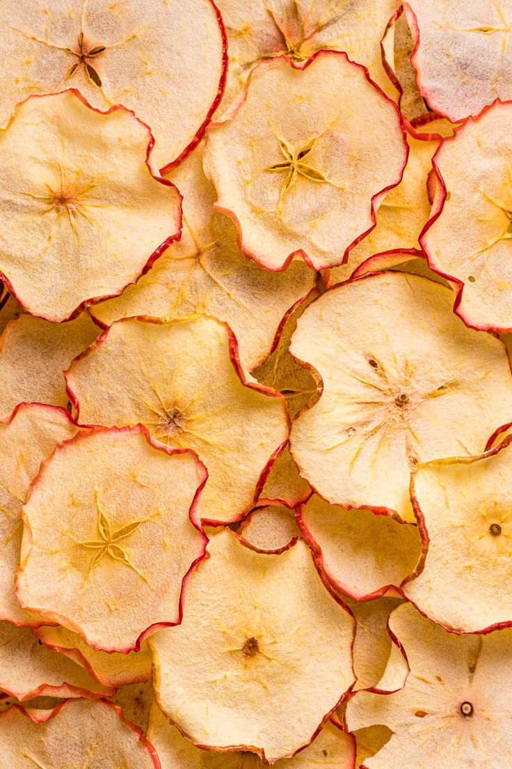 apple slices are arranged on top of each other in the shape of flowers and leaves