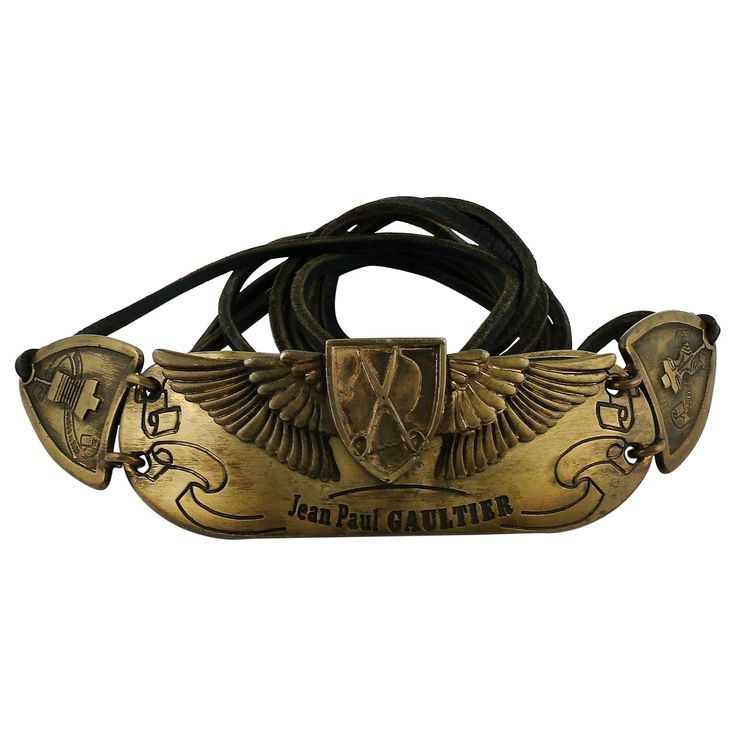 JEAN PAUL GAULTIER antiqued bronze toned belt featuring a 3-D buckle, featuring JEAN PAUL GAULTIER profile with sewing attributes. Black leather straps. Limited edition belt edited on the occasion of the 25th anniversary of the House of JEAN PAUL GAULTIER. Embossed JEAN PAUL GAULTIER Anniversaire 1976-2001. One size fits all. Can be worn in different ways (see examples on photos). Indicative measurements : total length approx. 280 cm (110.24 inches) / buckle approx. 25 cm x 5 cm (9.84 inches x 1 Chanel Vintage, Belt Black, Suspender Belt, Paul Gaultier, 25th Anniversary, Vintage Barbie, Jean Paul Gaultier, Jean Paul, Vintage Jeans