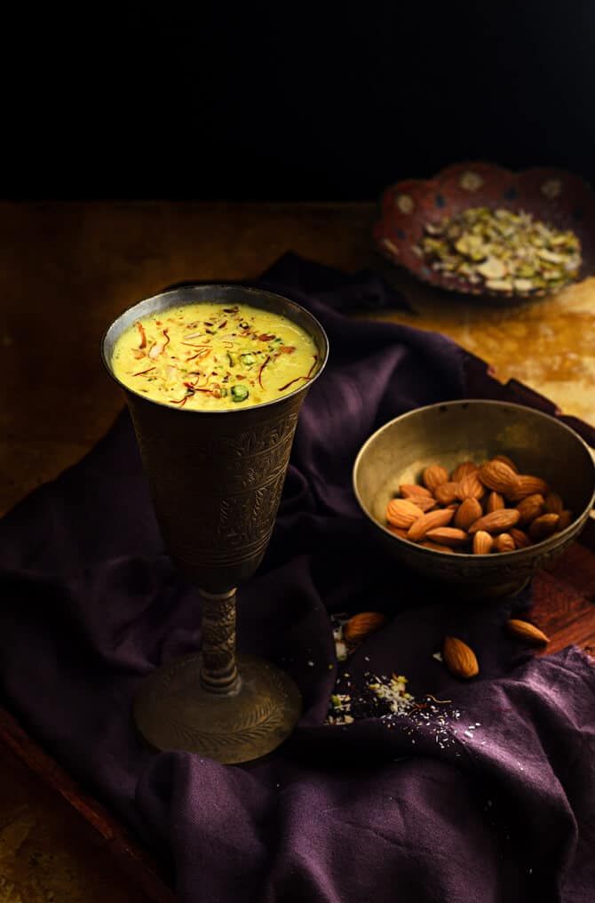 two bowls filled with food sitting on top of a table next to a purple cloth