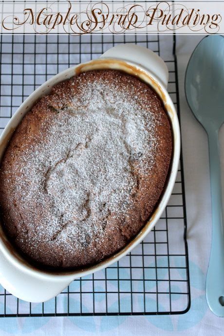 a cake sitting on top of a cooling rack next to a blue spoon and fork