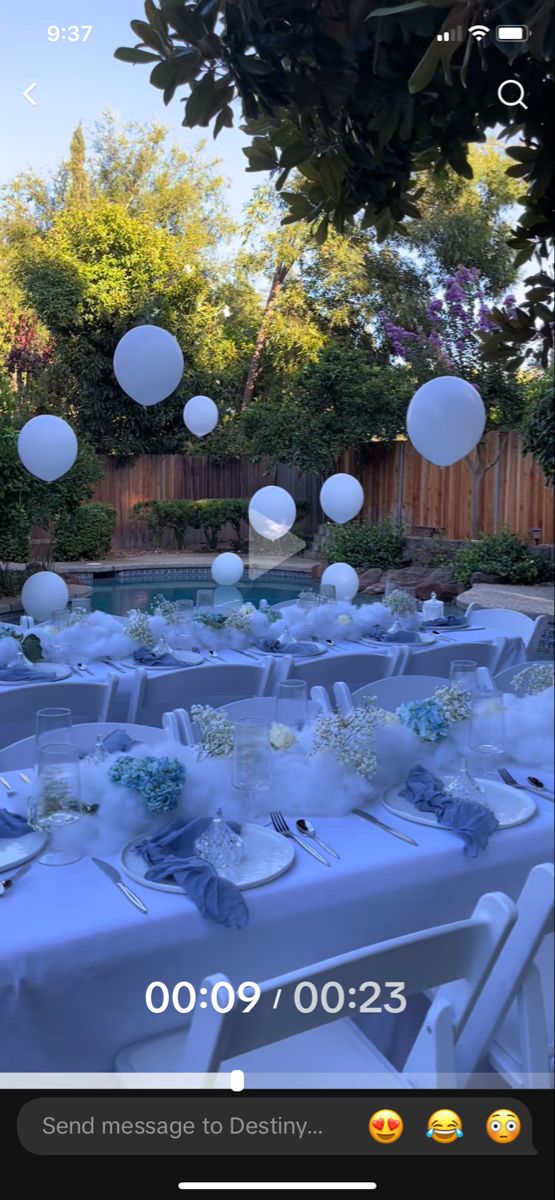 an outdoor event with balloons and tables set up in the yard for guests to enjoy