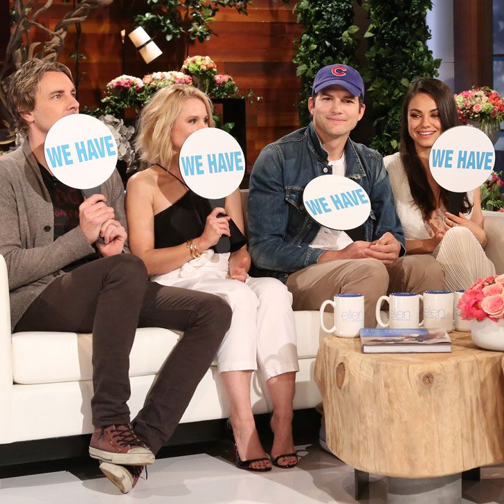 four people sitting on a couch holding up signs that read we have we have written on them