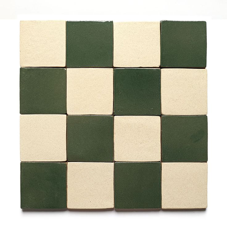 a green and white checkerboard tile pattern on a white background, with one square in the middle