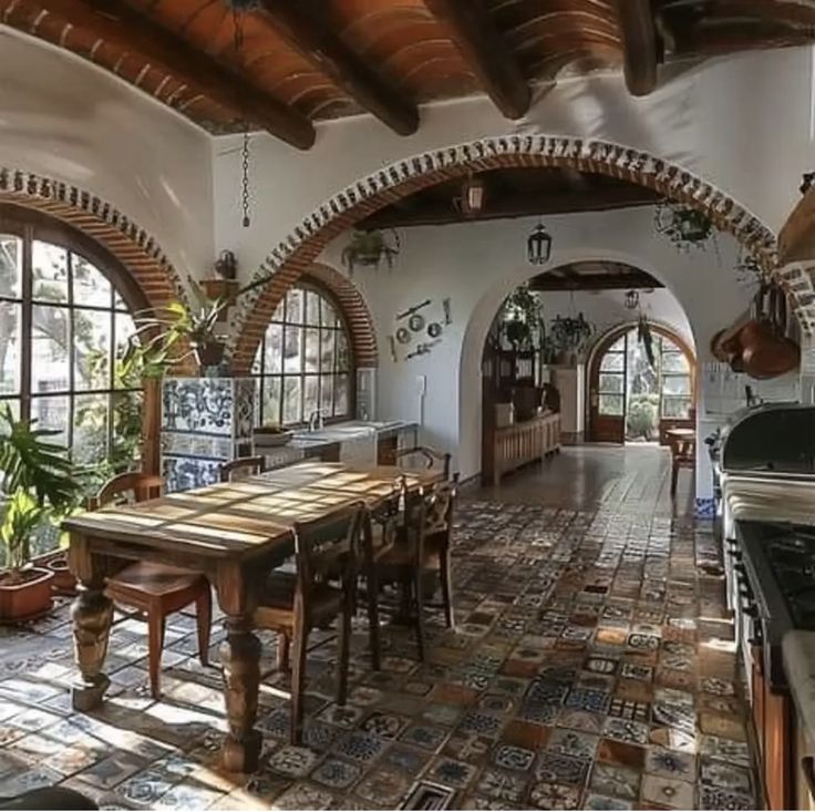 a kitchen with an arched ceiling and tile flooring