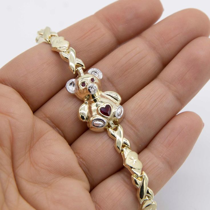 Diamond Cut Heart & Kisses Teddy Bear Bracelet Real 10K Yellow White Gold 7.5" * Metal : Real 10K Yellow White Gold (Properly Stamped, 10K) * Condition : Brand New * Finish : Polished * Average Weight : 5.98 grams * Length : 7.5" * Width : Bear: 17mm = Just under 11/16" Chain: 7mm = Just over 1/4" * Clasp/Bail : Lobster Lock All of our items are brand new and are shipped with a gift box. Bear Bracelet, Average Weight, Diamond Cut, Link Bracelets, Chain Link, Yellow White, Favorite Jewelry, Diamond Cuts, Jewelry Bracelets