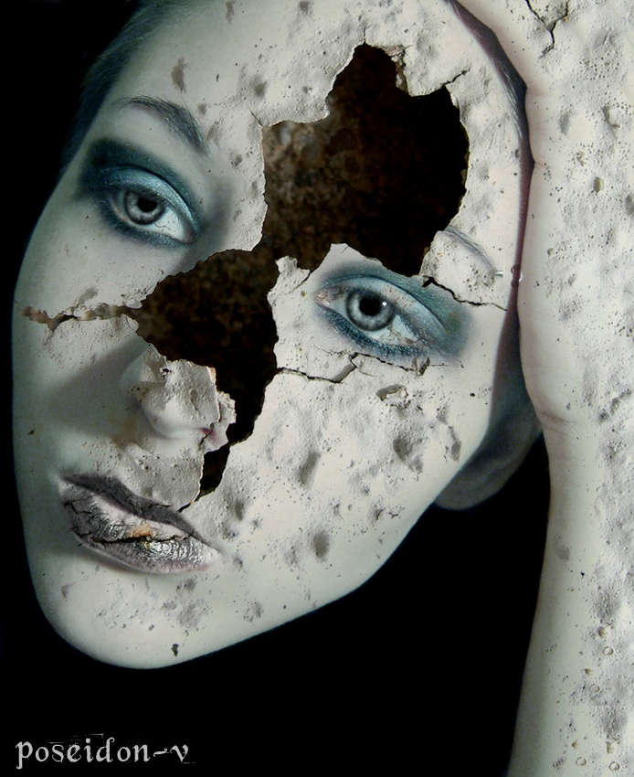 a woman's face is shown through a hole in the wall that appears to be cracked