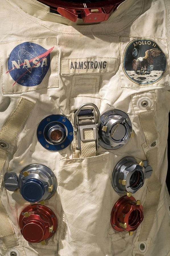 an astronaut's space suit with buttons and badges on the outer part of it