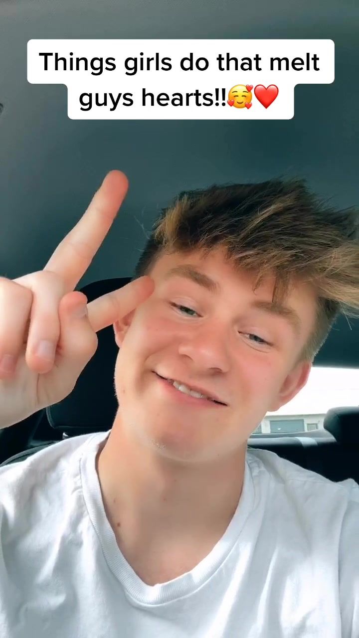 a young man making the peace sign with his fingers