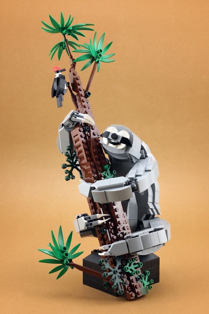 a lego model of a tree with animals on it