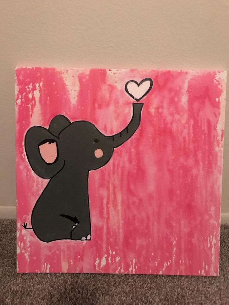 an elephant with a heart painted on it's trunk is standing in front of a wall