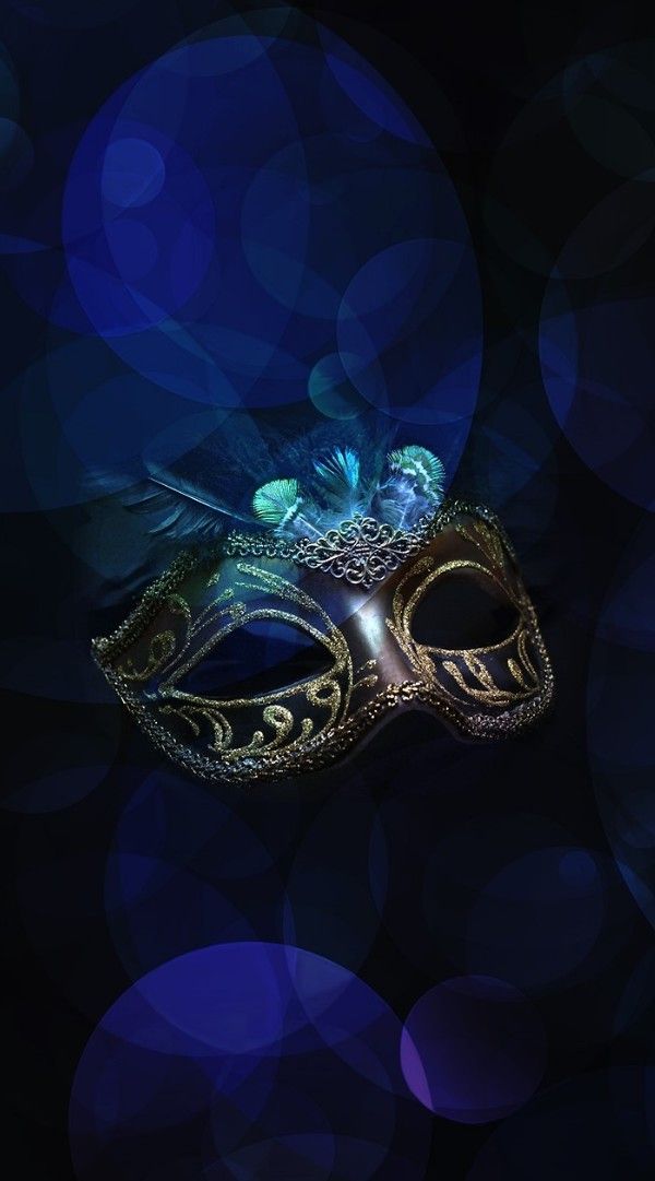 a masquerade mask with blue lights in the background