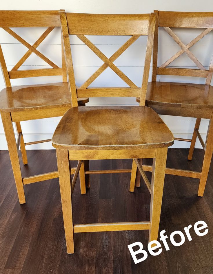 three wooden chairs sitting next to each other on top of a hard wood floored floor