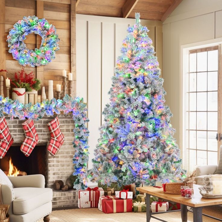 a decorated christmas tree in front of a fireplace