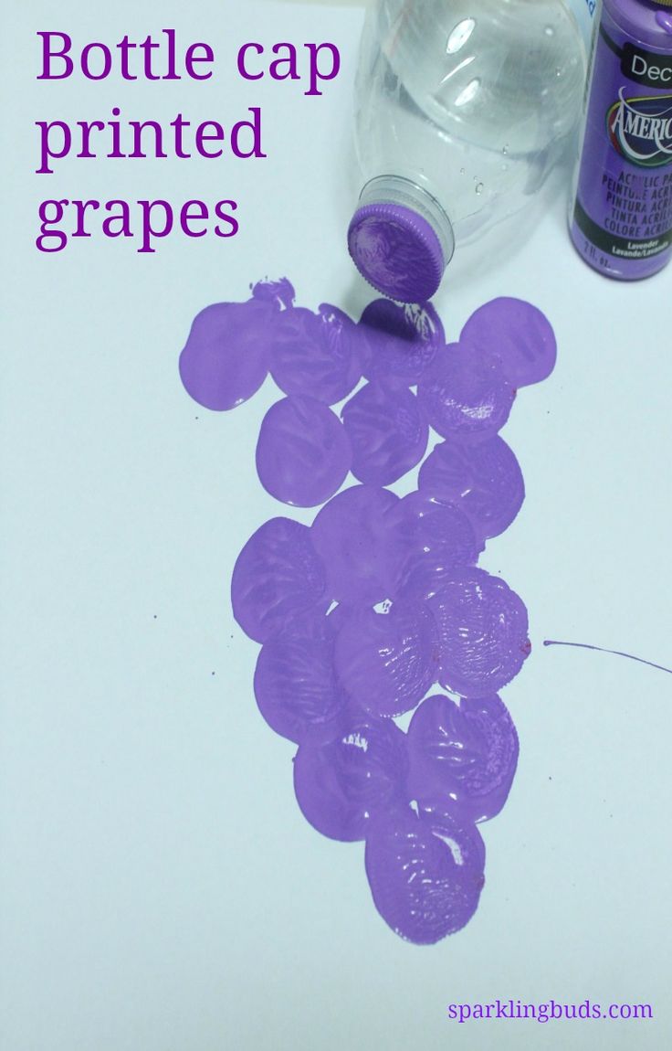 a bottle cap is sitting on top of grapes next to some glue and water bottles