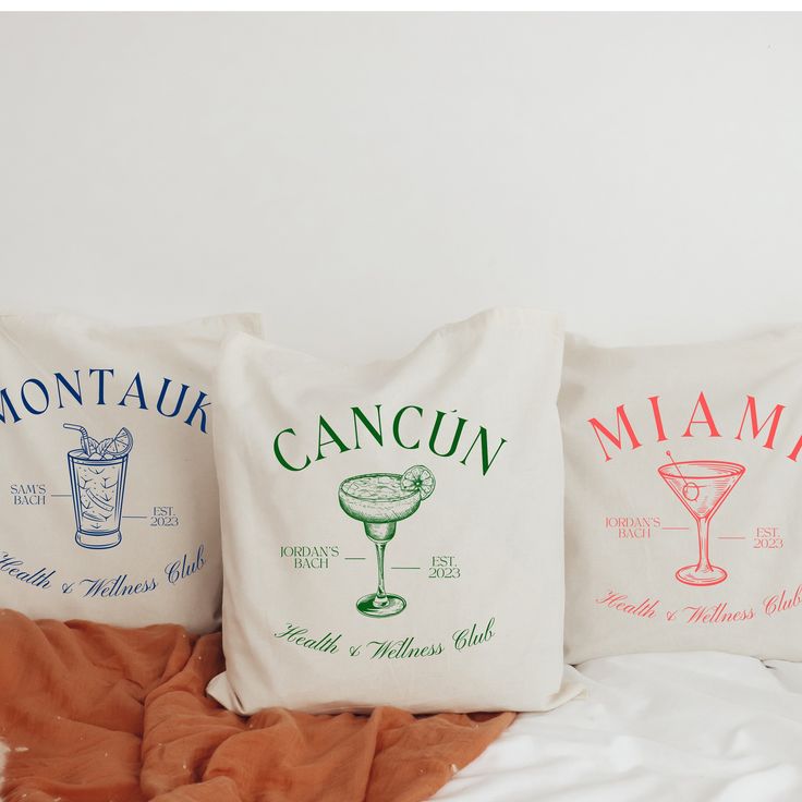 three pillows that have different types of drinks on them, one is white and the other is red