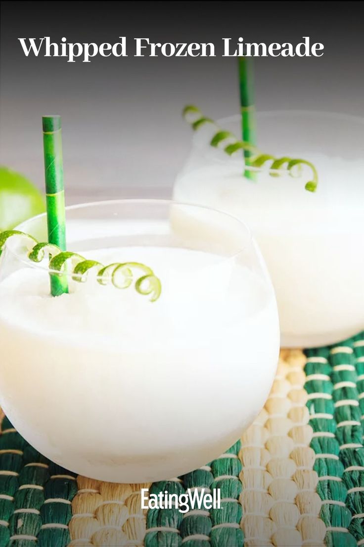 two glasses filled with liquid sitting on top of a table