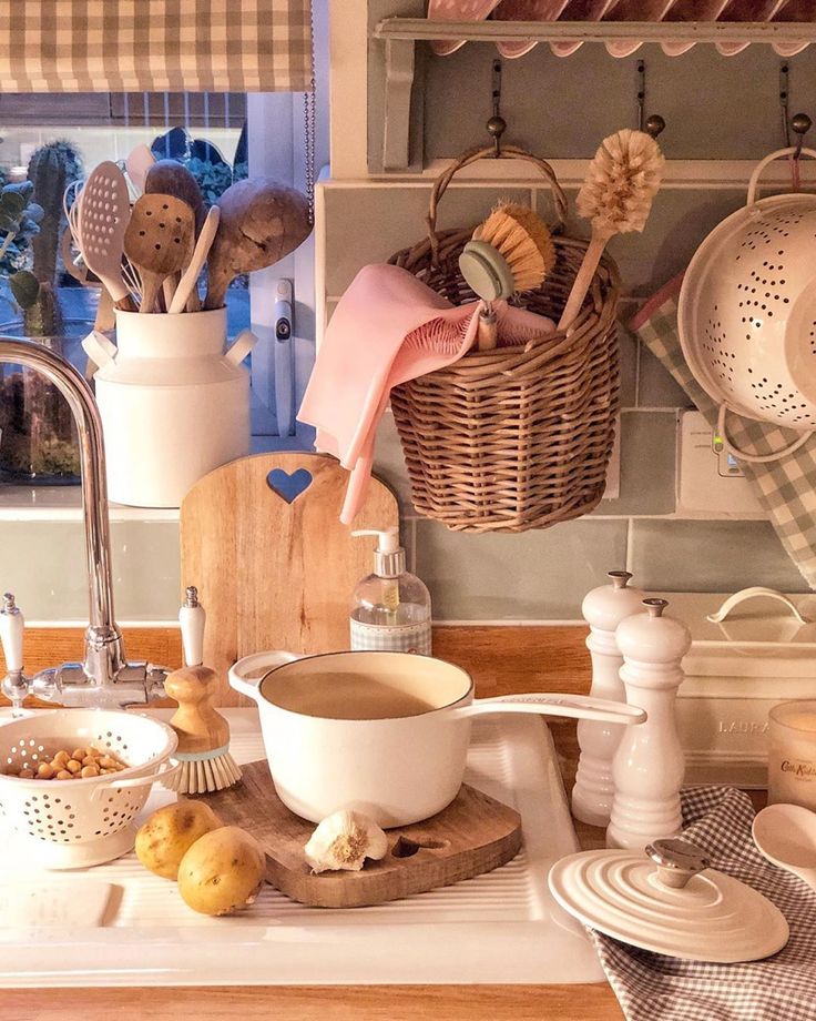 kitchen utensils and dishes are arranged on the counter