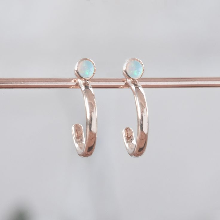 Custom Opal Birthstone Hoop Earrings | 14K Rose Gold displayed on holding bar. Honor Yourself, Staple Earrings, Opal Birthstone, White Gold Set, Metal Texture, Salt And Pepper Diamond, Stone Cuts, Gold Hoops, White Rose Gold