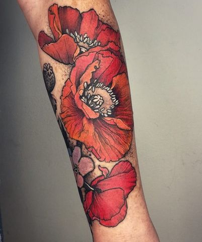 a woman's arm with red flowers on it