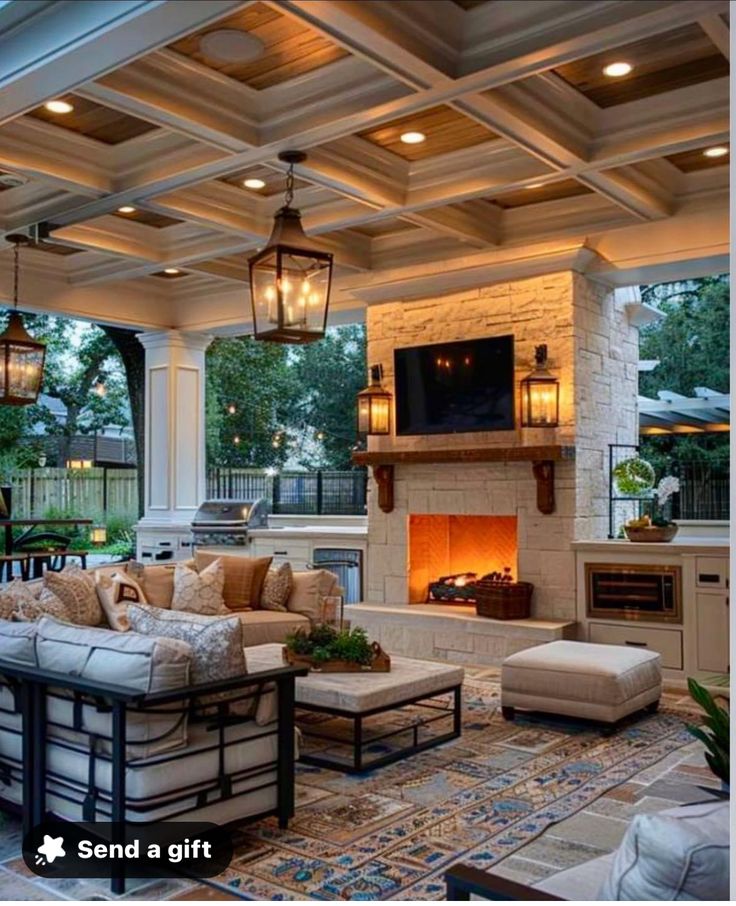 an outdoor living room with fireplace and seating