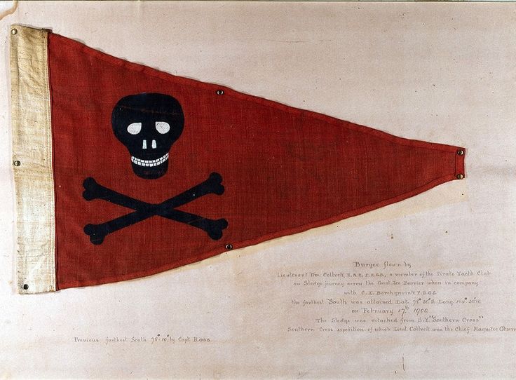 a pirate flag with a skull and crossbones on it, hanging from a wall