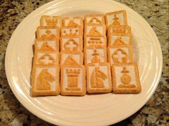 a white plate topped with cut out cookies