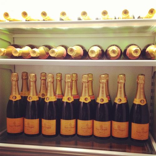 bottles of champagne are lined up in a refrigerator