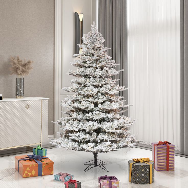 a white christmas tree with presents around it