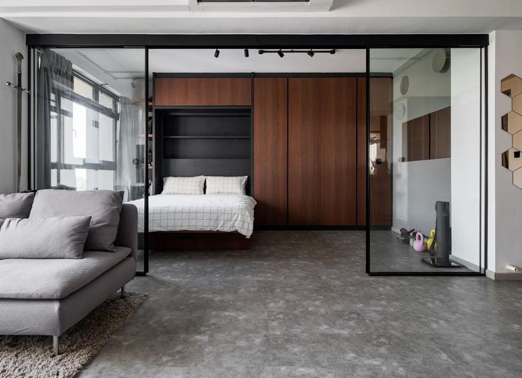 a living room with a couch, bed and sliding glass doors