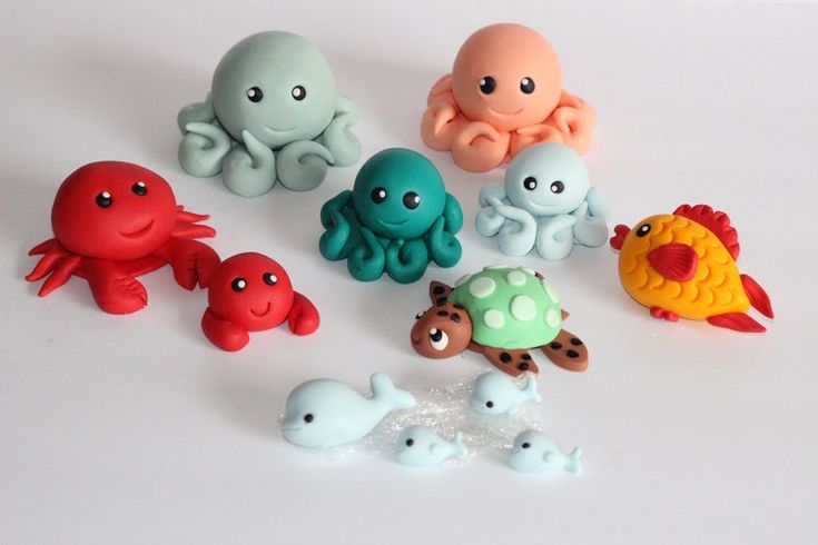 there are many small plastic toys that look like octopuses and sea creatures on the table