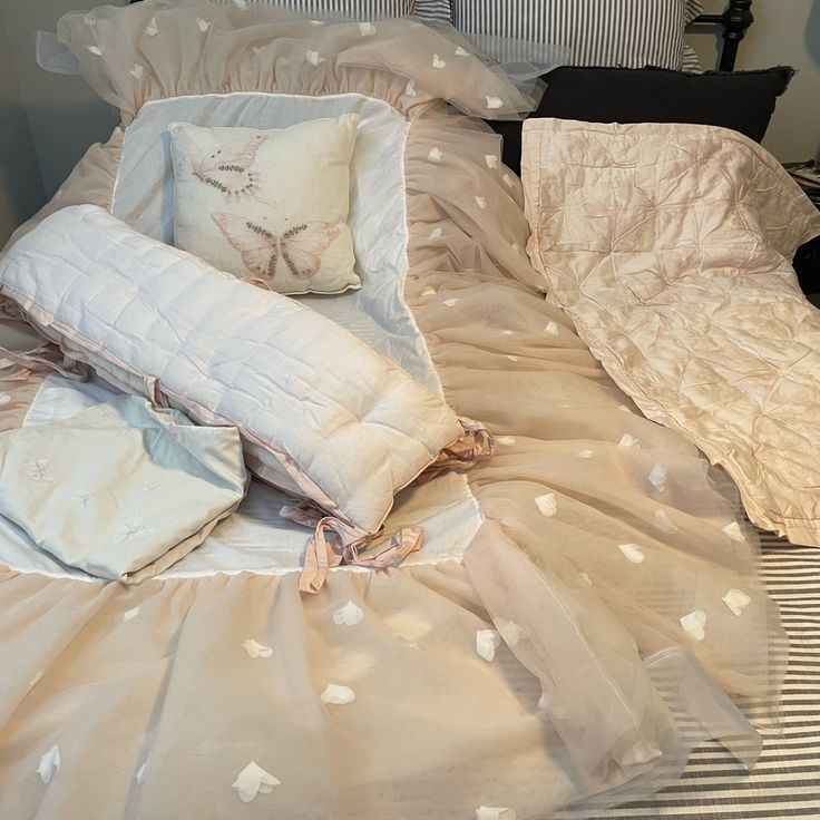 an unmade bed with two pillows on top of it and one pillow is laying down