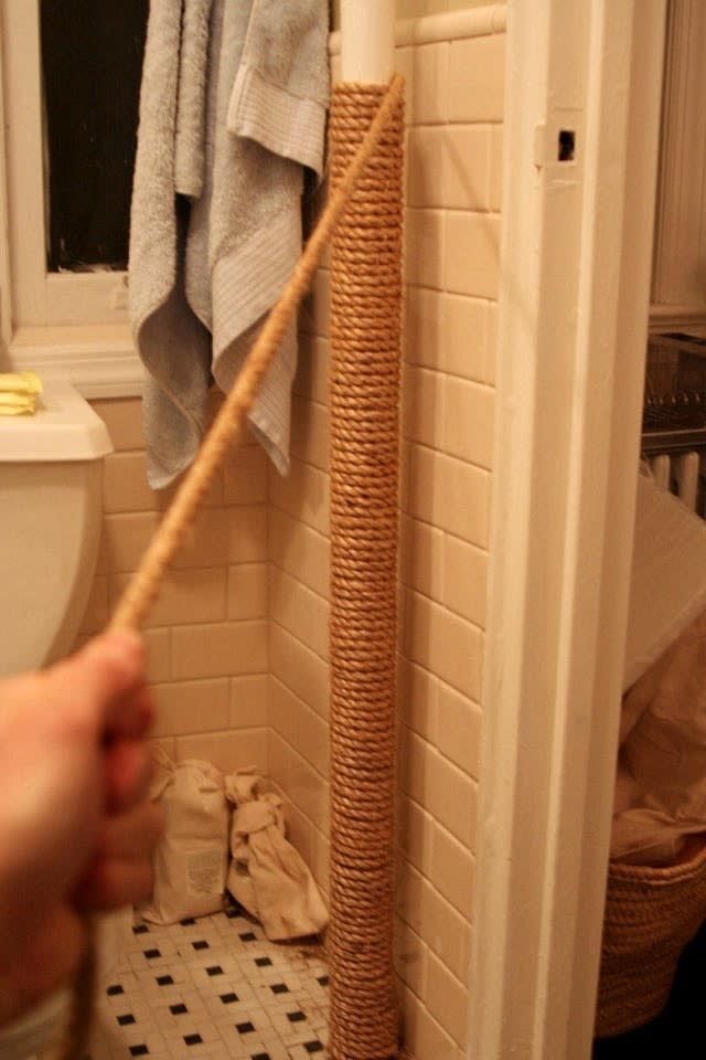 a person is holding a stick in the bathroom