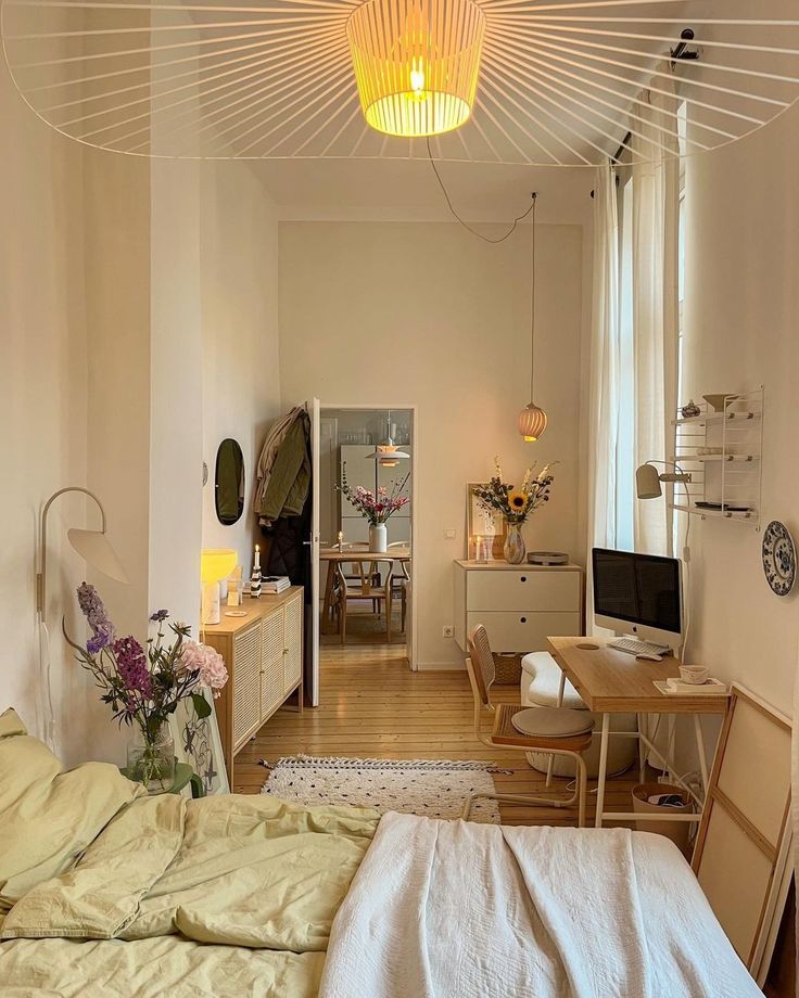 a bedroom with a bed, desk and television in it's centerpieces