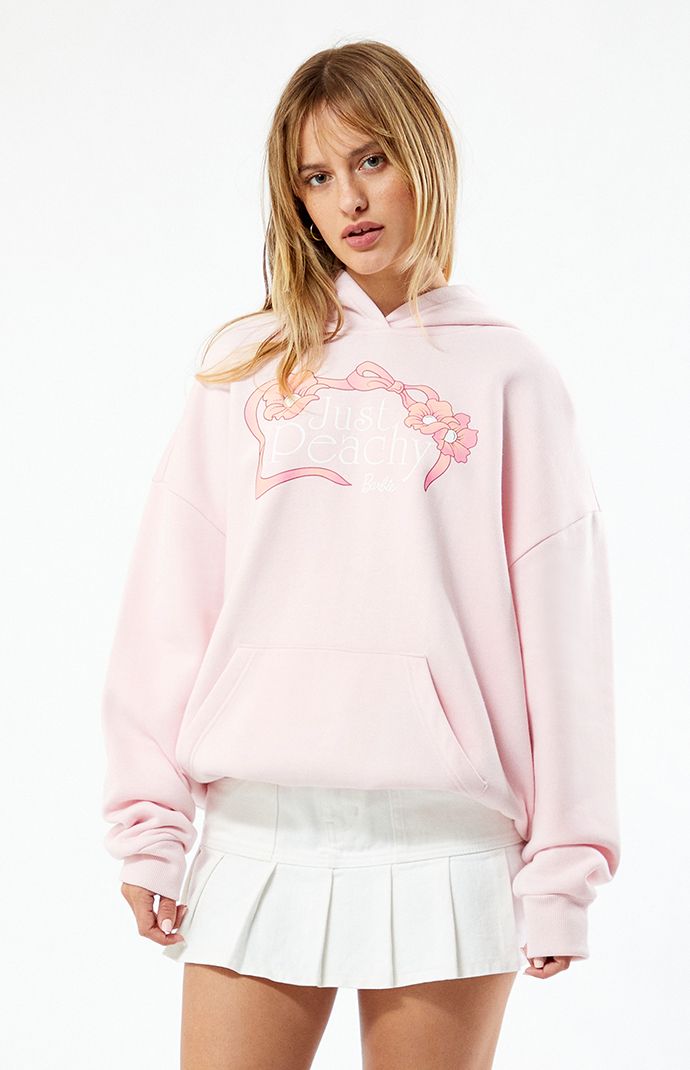 PacSun exclusive! Stay cozy and stylish with the Barbie Just Peachy Hoodie. Crafted with a soft fleece lining and featuring an attached hood, this hoodie offers warmth and comfort. Complete with a Barbie front graphic, kangaroo pocket, and oversized fit, it's perfect for adding a playful touch to your casual wardrobe while staying snug on chilly days.


	Solid color hoodie
	Attached hood
	Soft fleece lining
	Long sleeves
	Barbie graphic
	Kangaroo pocket
	Ribbed trimming
	Dropped shoulders
	Oversized fit
	60% cotton, 40% polyester
	Machine washable
	Model is wearing a size small
	Model measurements: 5’7” height, 32” bust, 23” waist, 34” hip Pacsun Tops, Pink Hoodie, Just Peachy, Women Hoodies Sweatshirts, Lifestyle Clothing, Colorful Hoodies, Pacsun, Casual Wardrobe, Aesthetic Outfits