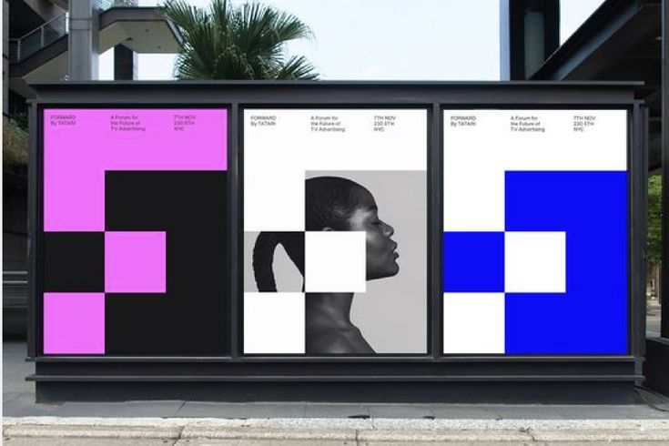 an outdoor display with multiple colored squares on it's sides and a woman's head in the center