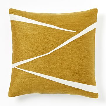 a yellow pillow with white lines on it