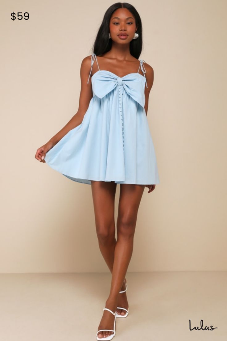 It's easy to fall in love with a look as sweet as the Flirtatious Babe Light Blue Tie-Strap Babydoll Mini Dress! Lightweight woven cotton shapes this cute dress that has ultra-thin, tying spaghetti straps that support a bodice with a sweetheart neckline and an oversized bow accent. High waist creates a babydoll silhouette atop a flaring mini skirt that boasts a line of decorative buttons at the front. Fit: This garment fits true to size. Length: Mid-thigh. Bust: Great for any cup size. Waist: Fitted - very fitted at natural waist. Hip: Not Fitted - fuller skirt allows room for hips. Undergarments: May be worn with a strapless bra, adhesive bra, petals, or no bra. Fabric: Fabric has no stretch. Lined. Self: 100% Cotton. Lining: 100% Cotton. Hand Wash Cold. Do Not Bleach. Lay Flat To Dry. Fo Light Blue Mini Dress, Mini Dress With Bow, 13 Birthday, Light Blue Tie, Casual Formal Dresses, Babydoll Mini Dress, Blue Summer Dresses, Lulu Fashion, Red Dress Boutique