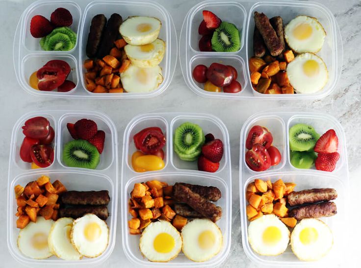 several plastic containers filled with different types of food