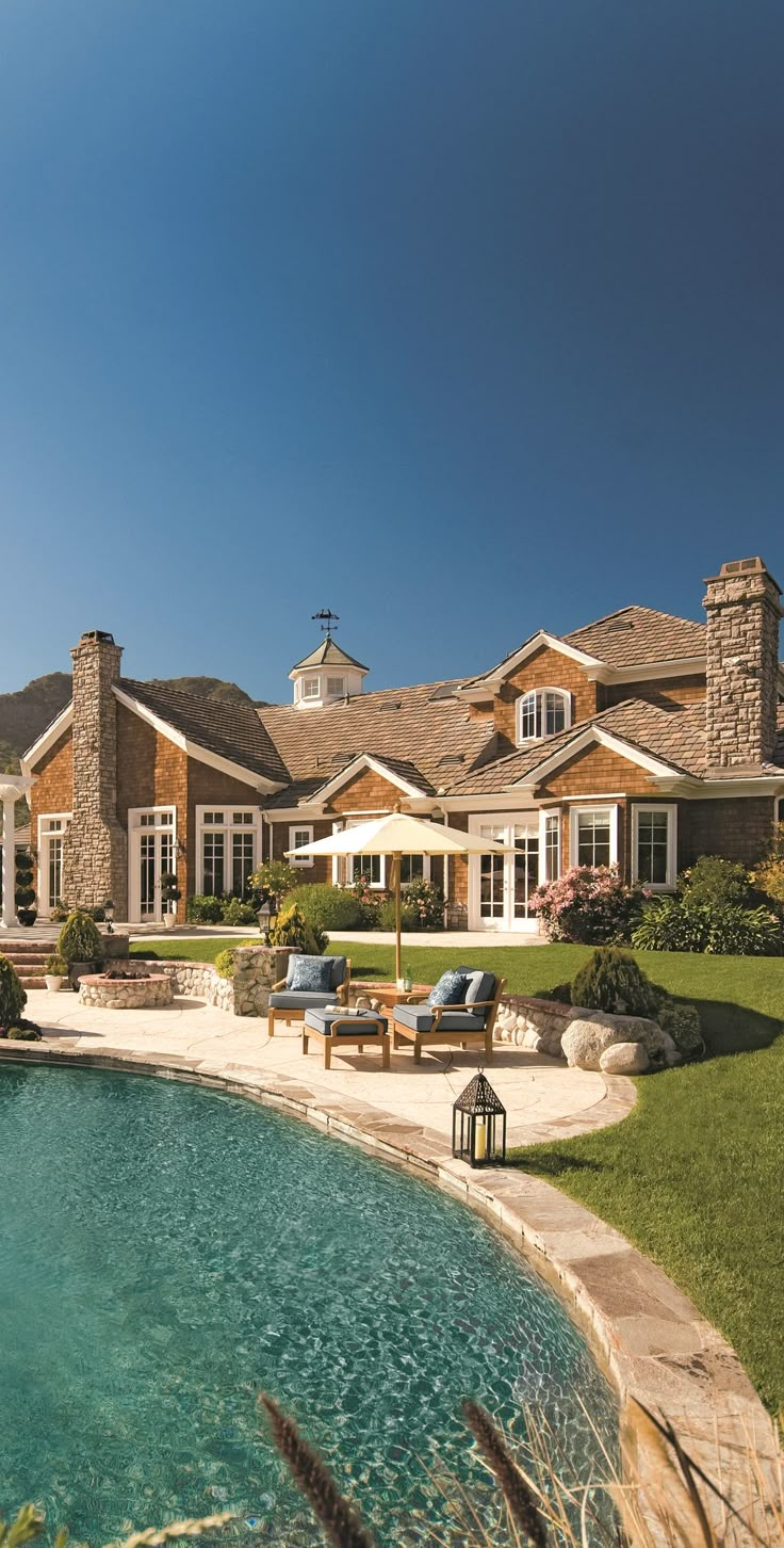 a large house with a pool in front of it